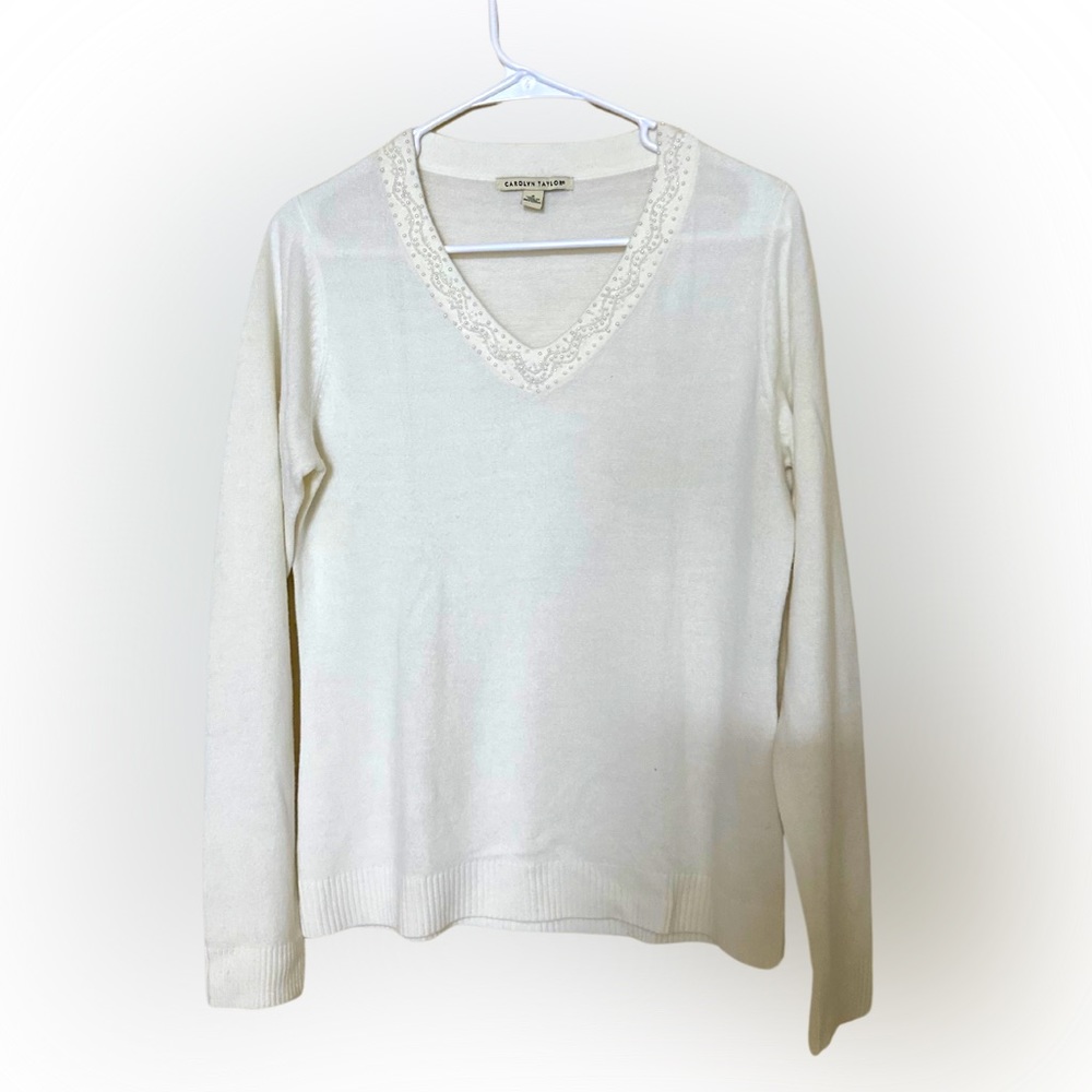 A white sweater from CAROLYN TAYLOR.